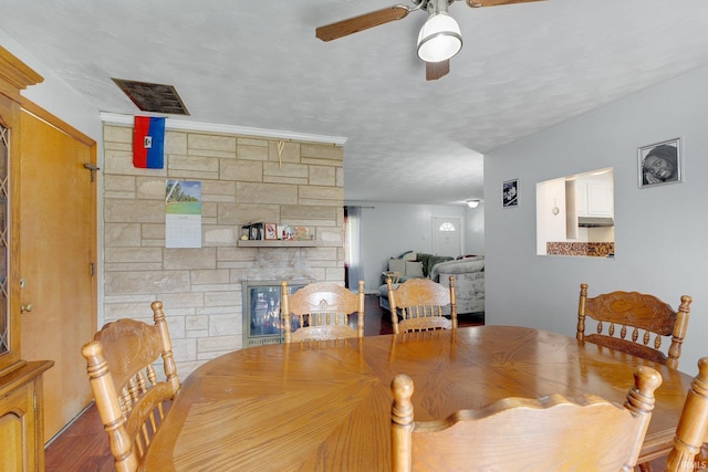 4893 Woodway Dr, Fort Wayne, IN 46835 - dining area featuring ceiling fan, wood finished floors, and a stone fireplace