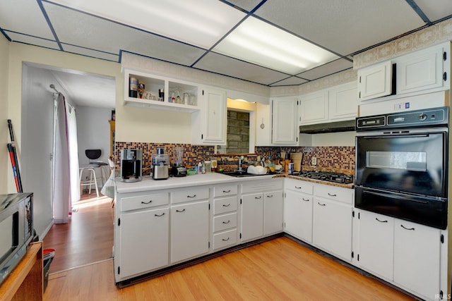 4893 Woodway Dr, Fort Wayne, IN 46835 - kitchen with black appliances, a warming drawer, light wood-type flooring, and white cabinetry