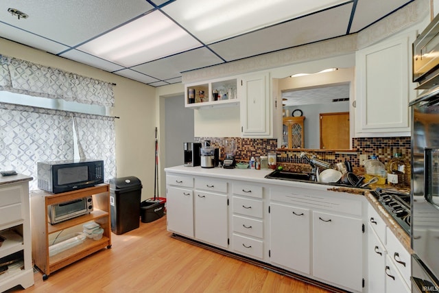 4893 Woodway Dr, Fort Wayne, IN 46835 - kitchen with open shelves, black appliances, backsplash, light wood finished floors, and white cabinetry
