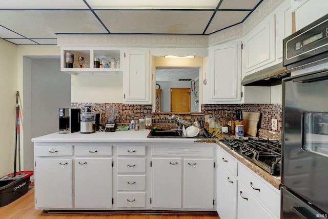 4893 Woodway Dr, Fort Wayne, IN 46835 - kitchen with black gas stovetop, white cabinetry, open shelves, and tasteful backsplash