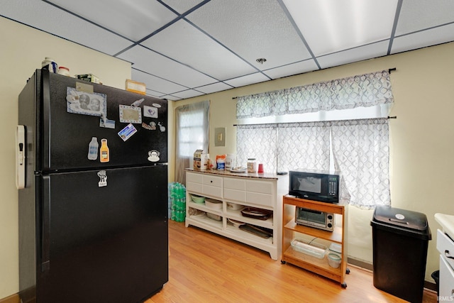 4893 Woodway Dr, Fort Wayne, IN 46835 - kitchen featuring black appliances, a drop ceiling, and light wood-style flooring