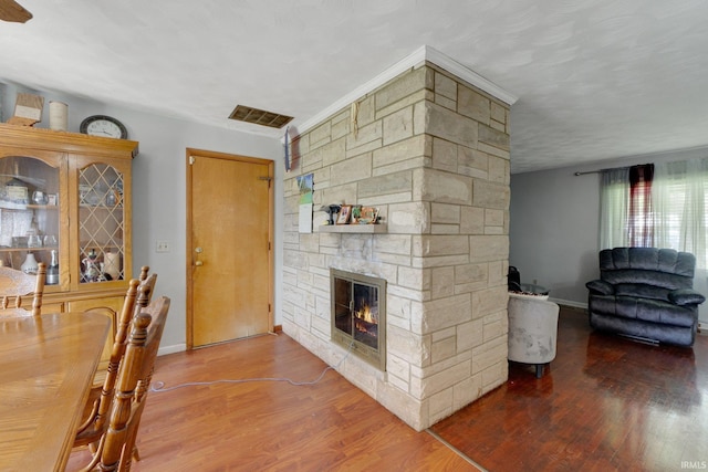 4893 Woodway Dr, Fort Wayne, IN 46835 - dining room with a stone fireplace, wood finished floors, and baseboards