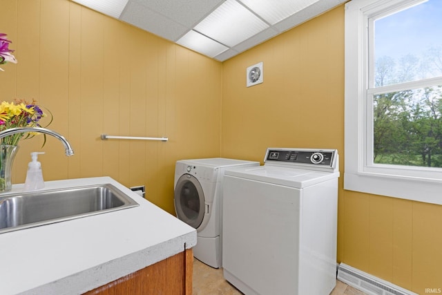 3550 Sandpoint Rd, Fort Wayne, IN 46809 - laundry area featuring baseboard heating, washer and dryer, a decorative wall, and cabinet space