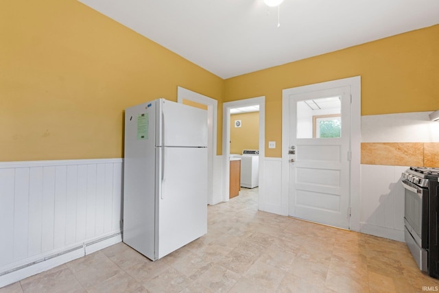 3550 Sandpoint Rd, Fort Wayne, IN 46809 - kitchen with freestanding refrigerator, a wainscoted wall, stainless steel gas range, and washer / clothes dryer