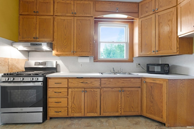 3550 Sandpoint Rd, Fort Wayne, IN 46809 - kitchen with stainless steel gas stove, under cabinet range hood, a sink, black microwave, and light countertops