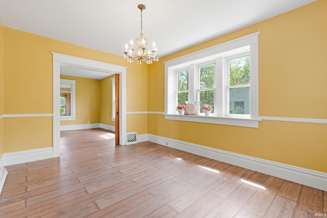 3550 Sandpoint Rd, Fort Wayne, IN 46809 - unfurnished room featuring healthy amount of natural light, a chandelier, and baseboards