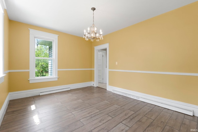 3550 Sandpoint Rd, Fort Wayne, IN 46809 - empty room featuring a chandelier, a baseboard heating unit, wood finished floors, and baseboards
