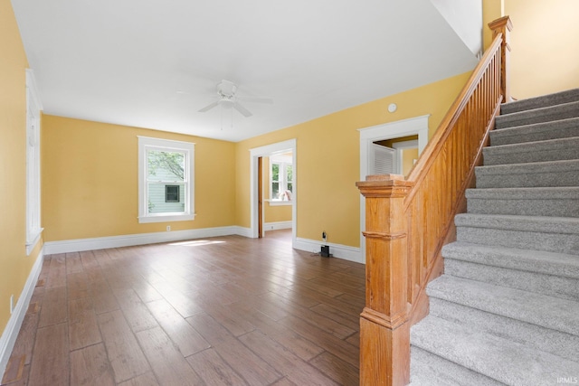 3550 Sandpoint Rd, Fort Wayne, IN 46809 - empty room featuring stairway, hardwood / wood-style floors, a ceiling fan, and baseboards