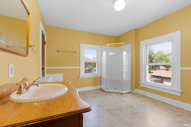 3550 Sandpoint Rd, Fort Wayne, IN 46809 - bathroom featuring a stall shower, plenty of natural light, vanity, and baseboards