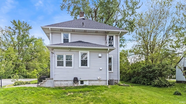 3550 Sandpoint Rd, Fort Wayne, IN 46809 - rear view of property with a lawn, a chimney, a shingled roof, and cooling unit
