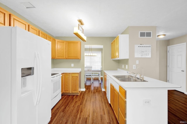 325 W Persimmon Ct, Bloomington, IN 47403 - kitchen with white appliances, a sink, a peninsula, wood finished floors, and light countertops