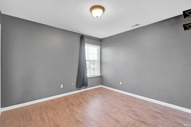 325 W Persimmon Ct, Bloomington, IN 47403 - empty room with wood finished floors and baseboards