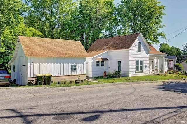 408 S Sale St, Ellettsville, IN 47429 - view of front facade with board and batten siding and a shingled roof