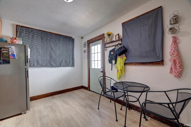 408 S Sale St, Ellettsville, IN 47429 - doorway featuring a textured ceiling, light wood finished floors, and baseboards