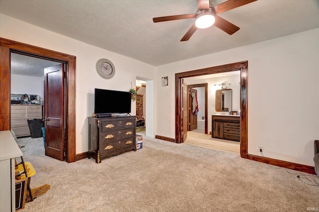 408 S Sale St, Ellettsville, IN 47429 - carpeted living area with baseboards, ceiling fan, and a textured ceiling