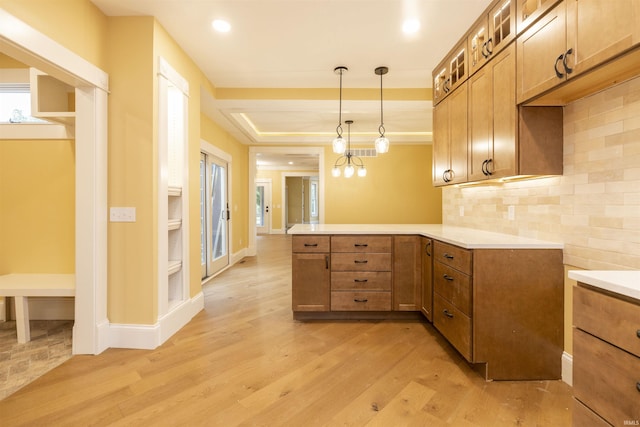324 W Mishawaka Ave, Mishawaka, IN 46545 - kitchen with a peninsula, light wood-style floors, brown cabinetry, glass insert cabinets, and recessed lighting