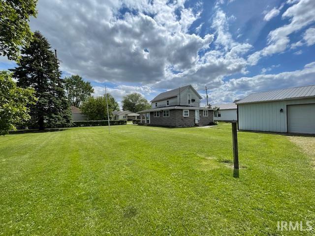1242 Edwin St, Huntington, IN 46750 - view of green lawn featuring a garage and an outbuilding
