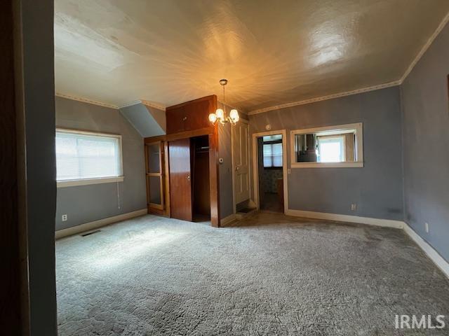 1242 Edwin St, Huntington, IN 46750 - unfurnished bedroom featuring a chandelier, carpet floors, baseboards, and crown molding
