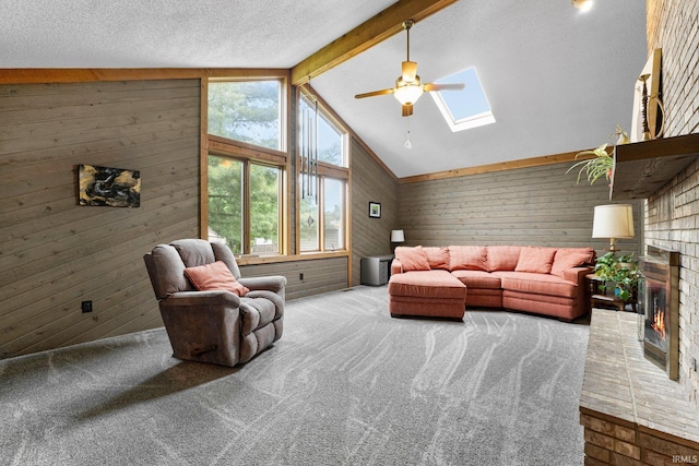 5318 Bedrock Ct, Fort Wayne, IN 46825 - living area featuring wood walls, a skylight, a brick fireplace, carpet floors, and ceiling fan