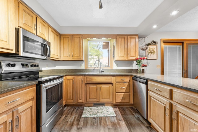 5318 Bedrock Ct, Fort Wayne, IN 46825 - kitchen with appliances with stainless steel finishes, a sink, recessed lighting, dark wood-style flooring, and a textured ceiling