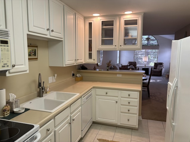 5242 Coventry Ln, Fort Wayne, IN 46804 - kitchen with white appliances, white cabinetry, light tile patterned floors, glass insert cabinets, and a sink
