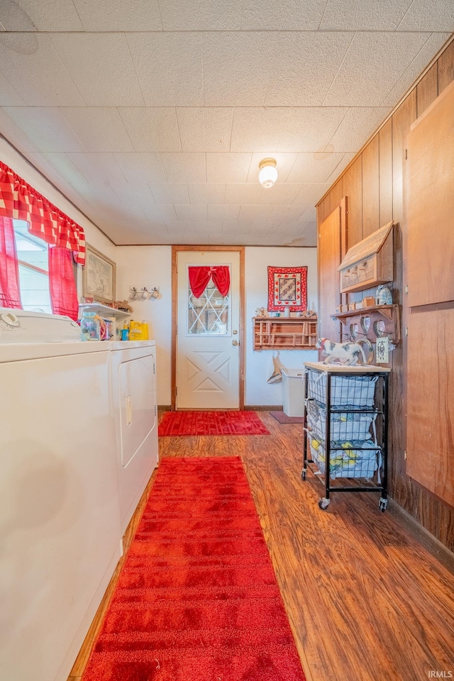 5026 N 450 W, Royal Center, IN 46978 - hallway with light wood-style flooring, washer and clothes dryer, and wood walls