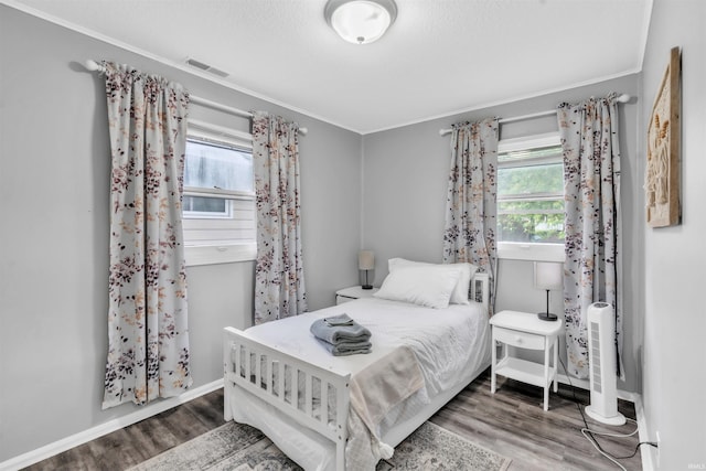 1122 Curdes Ave, Fort Wayne, IN 46805 - bedroom featuring multiple windows, wood finished floors, baseboards, and ornamental molding
