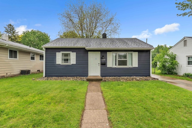 1122 Curdes Ave, Fort Wayne, IN 46805 - bungalow-style home with a front yard, cooling unit, and a shingled roof