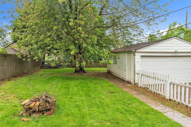 1122 Curdes Ave, Fort Wayne, IN 46805 - view of yard featuring an outdoor fire pit, a garage, and an outdoor structure