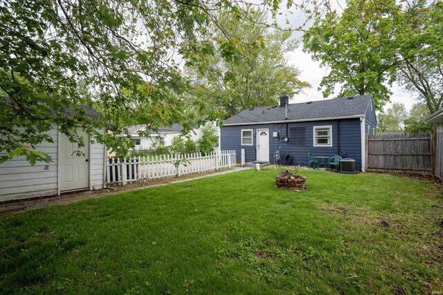 1122 Curdes Ave, Fort Wayne, IN 46805 - back of house with an outdoor fire pit, central AC unit, and an outdoor structure
