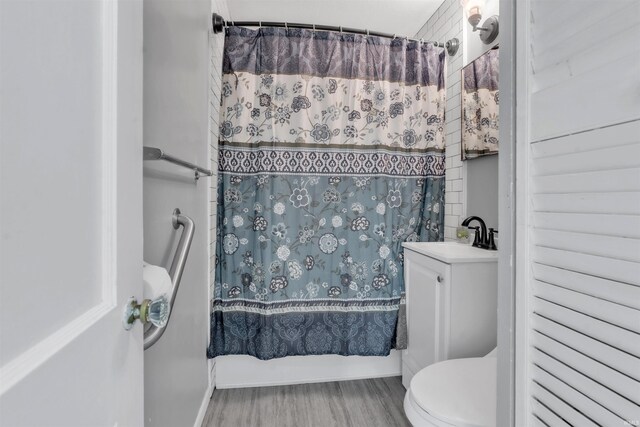 1122 Curdes Ave, Fort Wayne, IN 46805 - bathroom featuring a sink, wood finished floors, toilet, and shower / bath combo