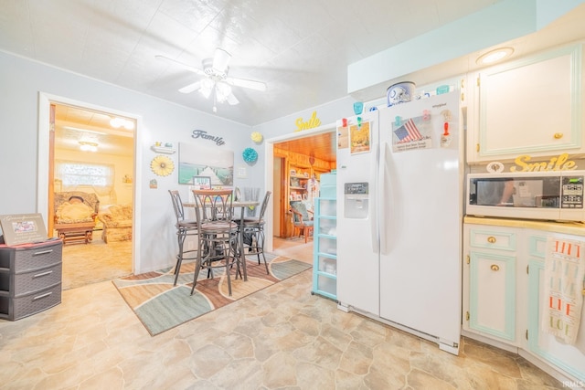 1402 W Chapel Pike, Marion, IN 46952 - kitchen with white appliances, ceiling fan, and light stone finish flooring