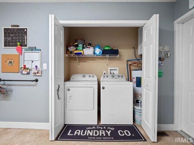 1346 Grayston Ave, Huntington, IN 46750 - laundry room featuring washing machine and clothes dryer, baseboards, and electric water heater