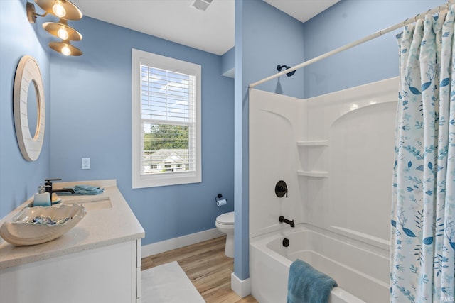 30860 Villa Dr, Granger, IN 46530 - full bath with shower / tub combo with curtain, baseboards, toilet, vanity, and wood finished floors
