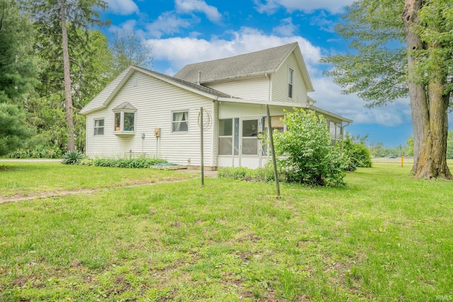 20 E Little St, Denver, IN 46926 - view of side of property featuring a lawn, a sunroom, and roof with shingles