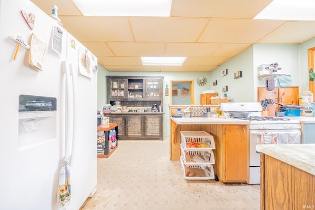 20 E Little St, Denver, IN 46926 - kitchen featuring white appliances, light countertops, a drop ceiling, and glass insert cabinets