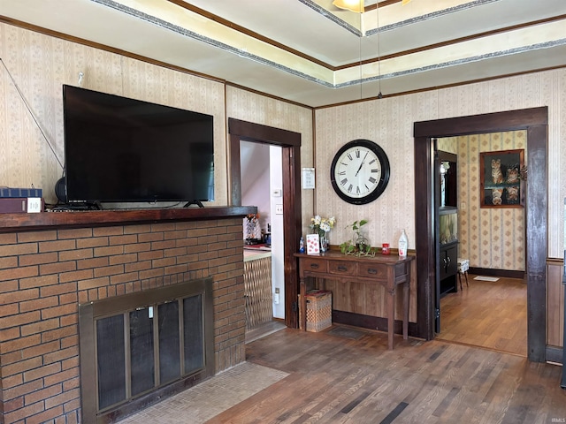 451 Miller Ave, Clarksville, IN 47129 - living area with wallpapered walls, wood finished floors, a fireplace, and crown molding