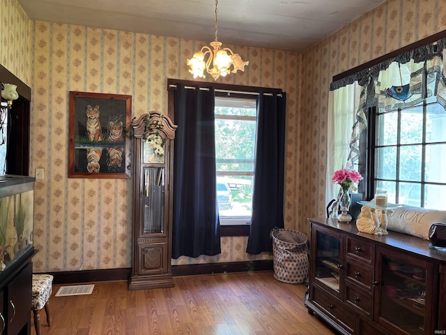 451 Miller Ave, Clarksville, IN 47129 - entryway featuring wood finished floors, a chandelier, wallpapered walls, and baseboards