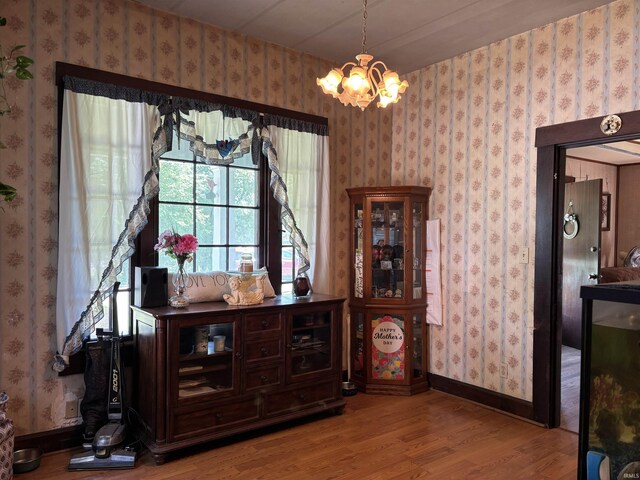 451 Miller Ave, Clarksville, IN 47129 - dining space with wood finished floors, a chandelier, and wallpapered walls