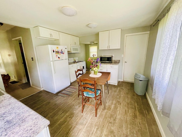 1206 N Walnut St, Plymouth, IN 46563 - kitchen featuring white appliances, wood finished floors, white cabinets, and baseboards