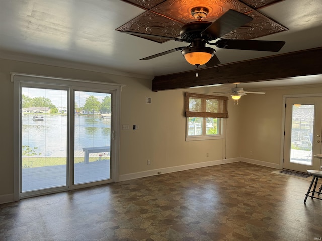 2109 Ball Ct, Rochester, IN 46975 - empty room with stone finish flooring, ceiling fan, baseboards, ornamental molding, and beam ceiling
