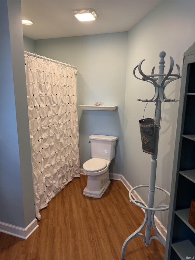 2109 Ball Ct, Rochester, IN 46975 - bathroom featuring toilet, wood finished floors, baseboards, and a shower with curtain