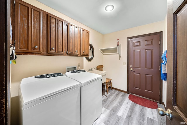 21485 Wallen Dr, South Bend, IN 46628 - washroom with washer and dryer, light wood-style floors, cabinet space, and baseboards