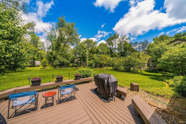21485 Wallen Dr, South Bend, IN 46628 - wooden deck with view of wooded area, a lawn, a grill, and outdoor dining area