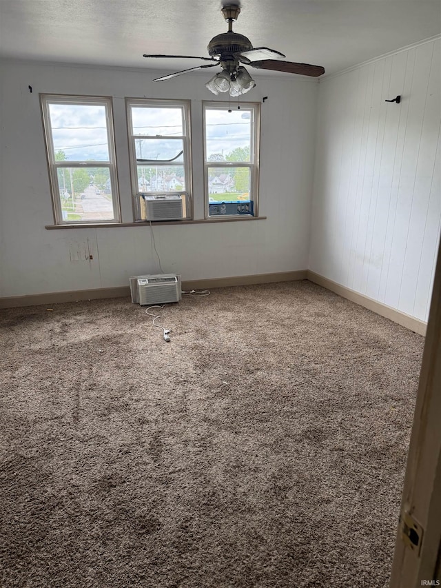 2606 Pennsylvania St, Evansville, IN 47712 - spare room with a ceiling fan, an AC wall unit, carpet floors, and baseboards