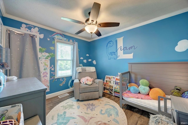 6447 W Delap Rd, Ellettsville, IN 47429 - bedroom with crown molding, wood finished floors, ceiling fan, baseboards, and a crib