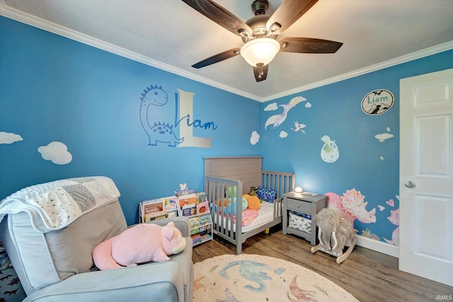 6447 W Delap Rd, Ellettsville, IN 47429 - bedroom featuring wood finished floors, ornamental molding, baseboards, and a ceiling fan