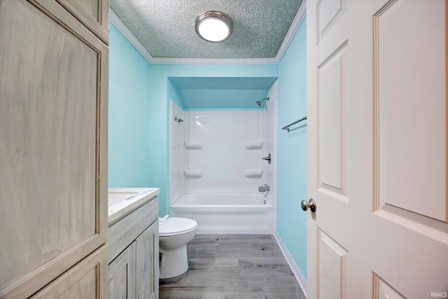 6447 W Delap Rd, Ellettsville, IN 47429 - bathroom featuring toilet, a textured ceiling, vanity, wood finished floors, and ornamental molding