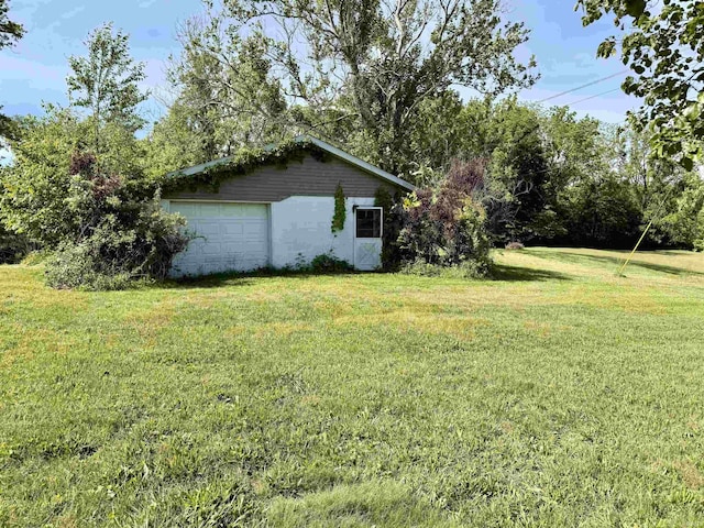 6447 W Delap Rd, Ellettsville, IN 47429 - view of grassy yard with a garage