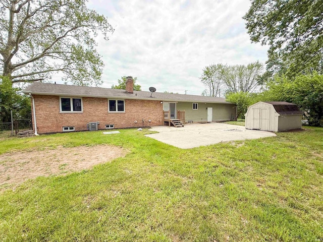 22073 County Road 10 W, Elkhart, IN 46514 - back of property with a patio, a chimney, entry steps, central AC, and brick siding